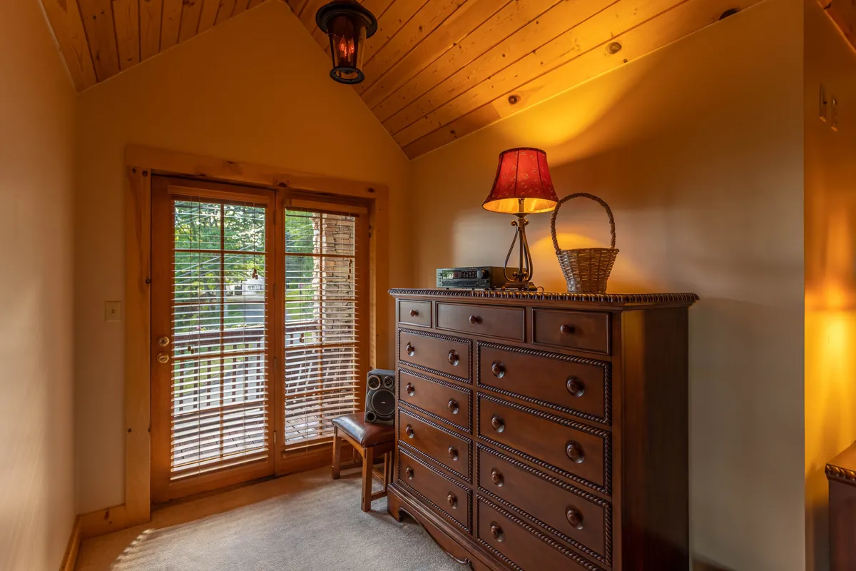 A warm, inviting room with double doors that open directly outside. The setup suggests easy access to outdoor areas, ideal for stepping out to observe nature or watch for local wildlife from a sheltered vantage point.